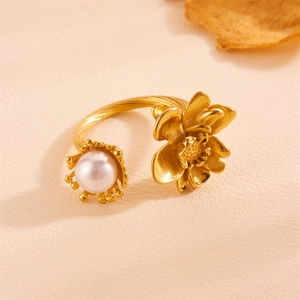 Elegant gold-tone titanium rose and pearl open ring featuring a textured twisted band