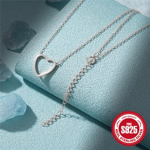 S925 sterling silver heart pendant necklace on blue stone display with logo cert