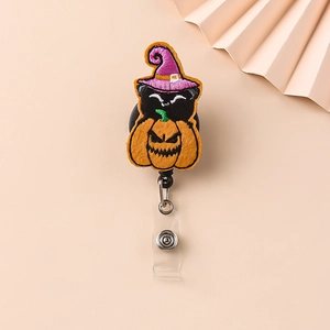 Detail of Halloween badge reel featuring felt black cat in pumpkin with retractable cord