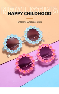 Detail of flower shaped kids sunglasses in blue and pink with a daisy petal frame design