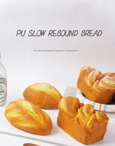 Detailed close-up of slow rebound PU artificial puff bread models on a white tray