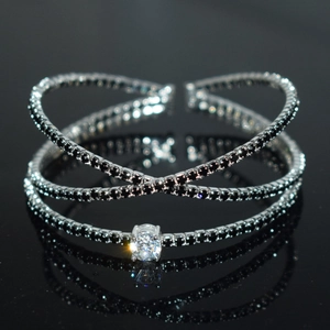 Macro view of luxurious silver bangle with crisscross design and black zircon stones