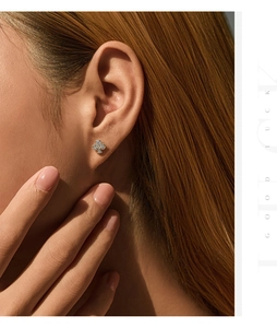 Close-up of S925 silver clover stud earrings with sparkling pavé moissanite on model
