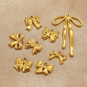 Set of eight gold stainless steel bow charms for DIY jewelry and earring making