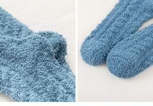 Close-up detail of blue coral fleece socks showing soft knitted texture and warm fabric