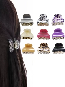 Macro view of small acrylic leopard print hair claws in nine various colors and patterns