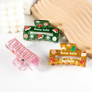 Glittery Christmas hair claw clips with Santa and snowflake patterns in three colors