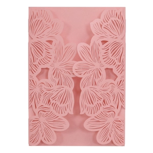 Macro detail of laser-cut floral pattern on soft pink pearlescent invitation card
