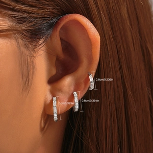 Detailed view of three silver hoop earrings in 0.6cm, 0.8cm, 1.0cm sizes on ear