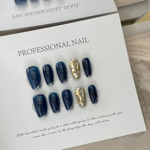 Deep blue cat-eye press-on nails with luxury champagne crystals and golden rhinestones