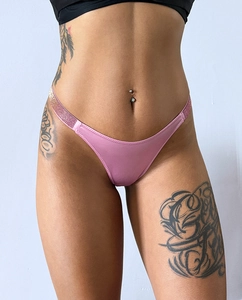 Detail of pink satin thong featuring luxury rhinestone side straps on female model
