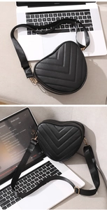 Detail of heart-shaped crossbody bag with V-quilted faux leather and golden hardware