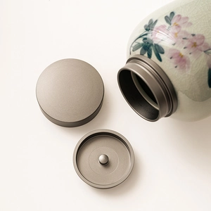 Ice-crack glaze ceramic tea canister with hand-painted pink floral pattern and double metal lids