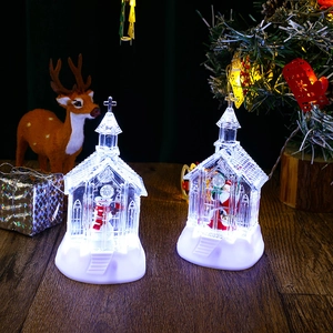 Detail of Christmas church-shaped LED lanterns with Santa and Snowman figures inside