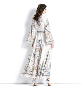 Detail of floral printed maxi dress with bell sleeves and bohemian pattern design