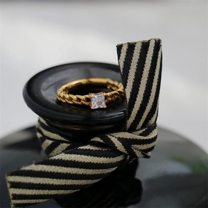 Macro shot of 18K gold-plated chain-link ring featuring a square-cut zircon stone
