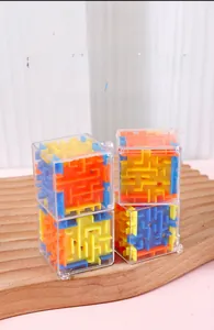 Close-up of 3D transparent maze cube toys stacked on a wooden base for kids' focus
