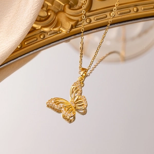 Elegant gold butterfly pendant necklace with micro-paved zircons on a champagne silk background