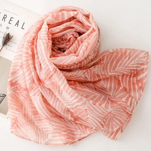 Detail shot of soft pink and white leaf pattern scarf with lightweight texture