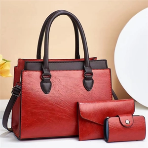 Three-piece red bag set including a large tote and wallets with pleated leather texture