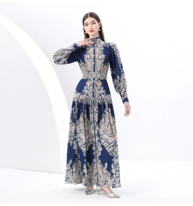 Detailed close-up of vintage paisley print on a dark blue long sleeve midi dress