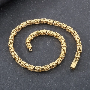 Macro detail of golden Byzantine chain link texture and box clasp on leather surface