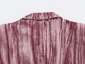 Detail of the pink velvet blazer collar showing fabric texture and premium stitching