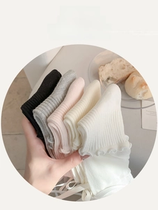 Detailed view of ribbed knit socks with ruffled edges in five soft pastel color variants