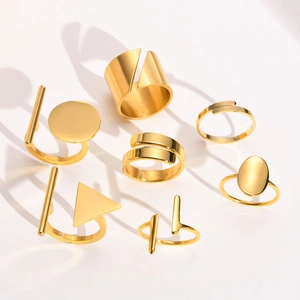 Detail view of gold geometric stainless steel rings with mirror and brushed finishes