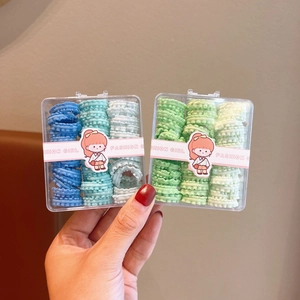 Detailed view of elastic wavy hair ties in blue and green gradient sets for children