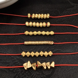 Matte gold bead collection for DIY jewelry featuring various textures on red cord