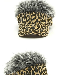 Detail view of leopard print baseball cap with funny grey wig hair on white background