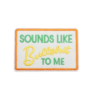 Rectangular white embroidery patch with orange border featuring humorous English text