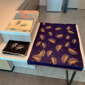 Detail of pashmina scarves showing ginkgo leaf patterns in various vibrant colors