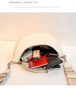 Internal view of cream crescent bag showing storage for makeup and wallet