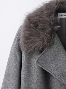 Detailed macro view of the fluffy grey faux fur collar on an elegant wool coat