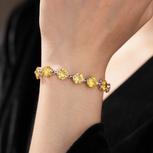 Detailed view of yellow zircon bracelet with silver base on model wrist for elegant style