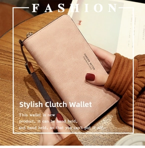 Detail of pink faux leather long wallet with zipper closure and wrist strap