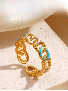 Macro view of adjustable gold chain ring with pink and sky blue enamel dripping oil detail