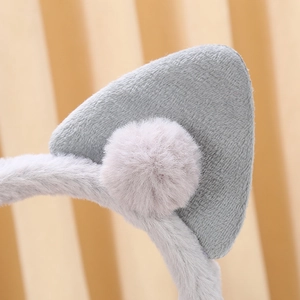 Detailed view of the soft grey plush fabric and pom-pom on the cat ear headband