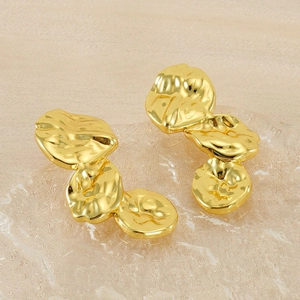 Macro shot of gold stainless steel earrings with irregular lava ripple petals and mirror finish