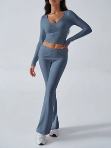 Blue knit two-piece set featuring V-neck cropped top and matching flared pants