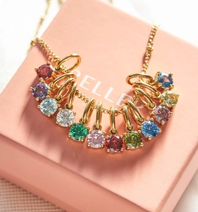 Macro shot of colorful birthstone pendants set in gold on a fine necklace chain