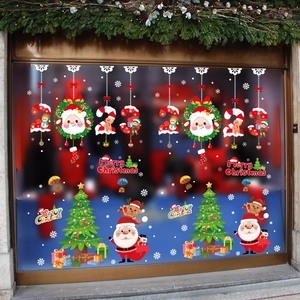 Detail of Christmas window stickers with Santa, reindeer and tree on glass pane