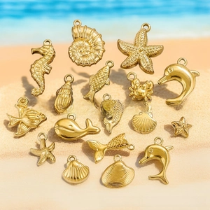 Detailed set of 15 gold marine charms on sand showing ocean-themed DIY jewelry parts