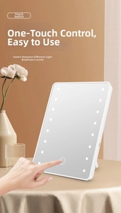 Detail view of LED makeup mirror with 16 bulbs and touch sensor on a desktop