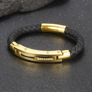 Detail of titanium steel leather bracelet with gold plating and cubic zirconia inlay