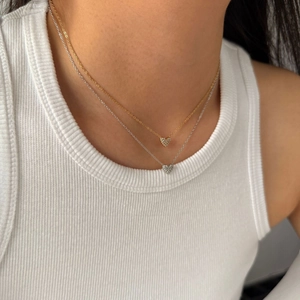 Exquisite gold and silver heart pendant necklaces with micro-pave crystals on model