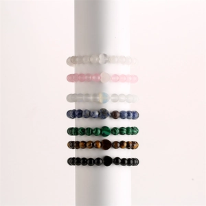 Detailed stack of heart-shaped natural stone bead bracelets in seven vibrant colors