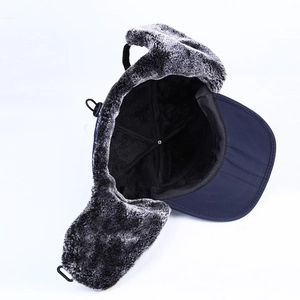 Deep blue winter trapper hat with warm grey faux fur lining and adjustable cord